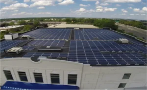 large array of solar panels on roof of industrial building